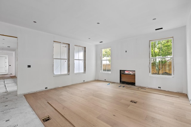 931 Kincade Dr, Mount Pleasant, SC 29464 - unfurnished living room with plenty of natural light and wood finished floors
