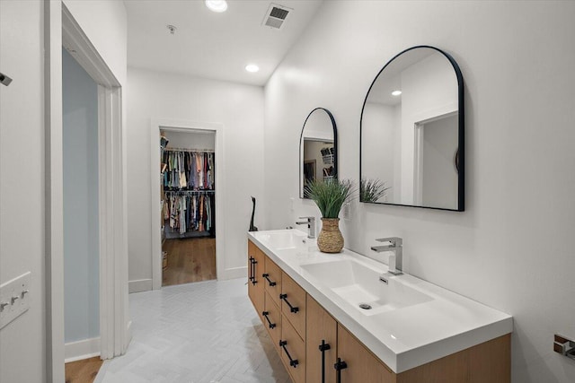 full bath with recessed lighting, visible vents, a sink, and double vanity