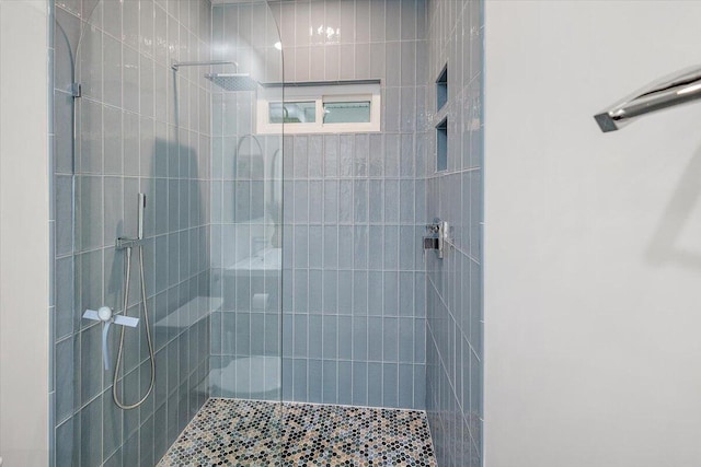 full bath featuring a tile shower