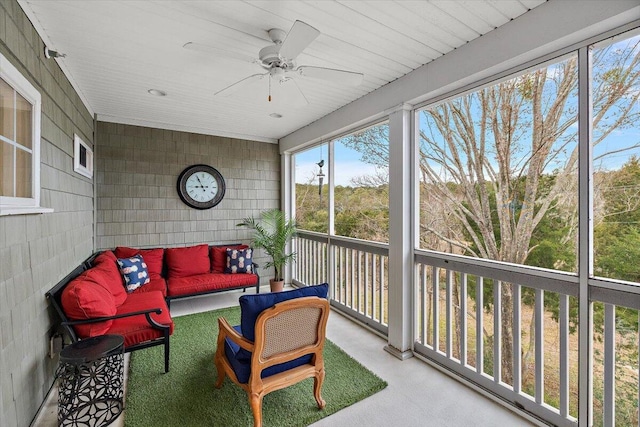 sunroom / solarium featuring ceiling fan