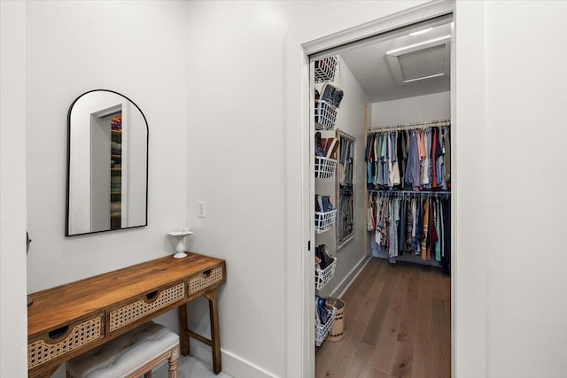 spacious closet featuring attic access and wood finished floors