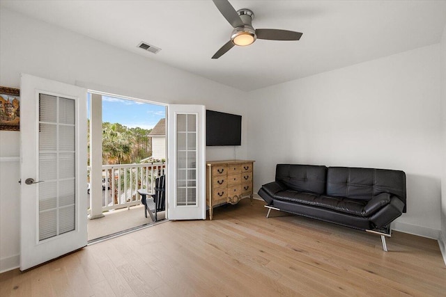 sitting room featuring baseboards, visible vents, ceiling fan, wood finished floors, and french doors