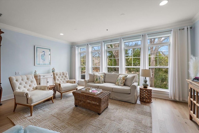 living room with light wood-style floors, a wealth of natural light, crown molding, and recessed lighting