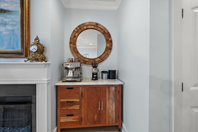 bathroom with a fireplace, crown molding, and vanity