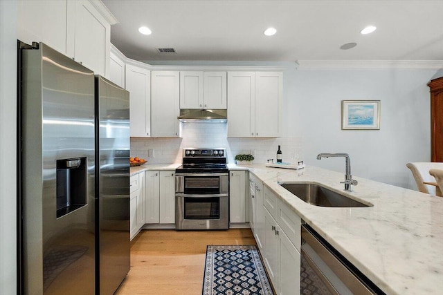 kitchen with visible vents, stainless steel appliances, crown molding, under cabinet range hood, and a sink