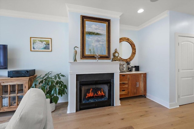 living area with baseboards, a lit fireplace, crown molding, light wood-style floors, and recessed lighting