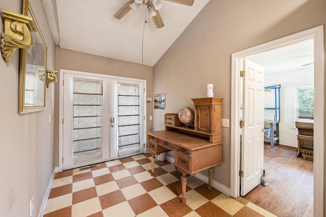 entrance foyer featuring ceiling fan, baseboards, light flooring, and vaulted ceiling