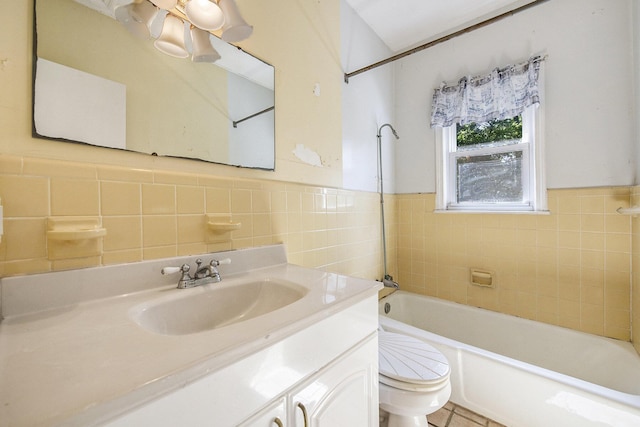full bathroom featuring toilet, tile walls, vanity, wainscoting, and shower / washtub combination