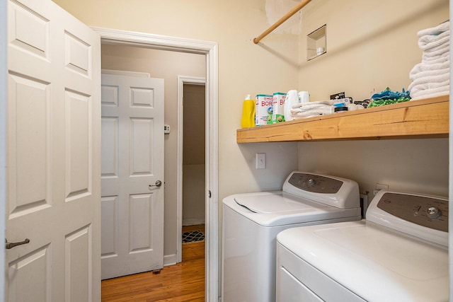 washroom with separate washer and dryer and light wood-style floors