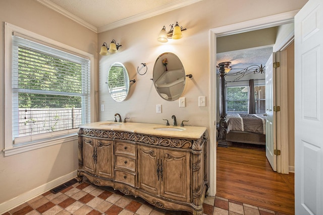 full bath featuring ornamental molding, ensuite bath, baseboards, and double vanity