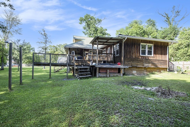 back of property featuring a yard, a deck, stairway, and crawl space