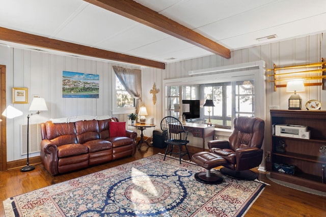 living room featuring beamed ceiling, wood finished floors, visible vents, and a healthy amount of sunlight