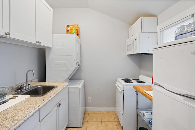 laundry area with a sink, light tile patterned floors, baseboards, stacked washer and clothes dryer, and laundry area
