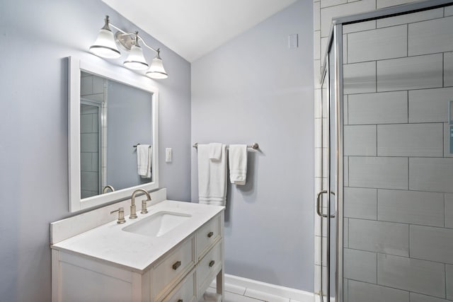 full bath with vaulted ceiling, vanity, and a stall shower