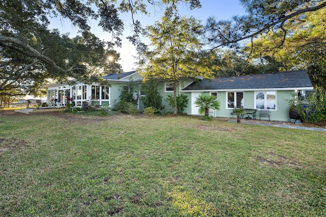 view of front facade featuring a front lawn and stucco siding