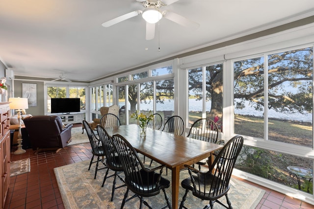 sunroom with crown molding and tile patterned floors