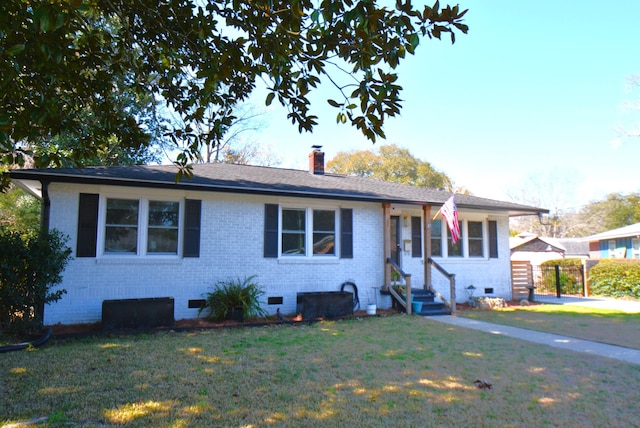 ranch-style home with a front lawn, entry steps, crawl space, brick siding, and a chimney