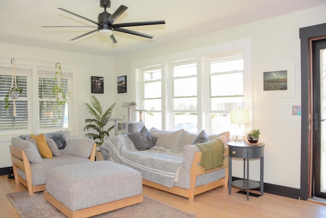 living area featuring a ceiling fan and wood finished floors