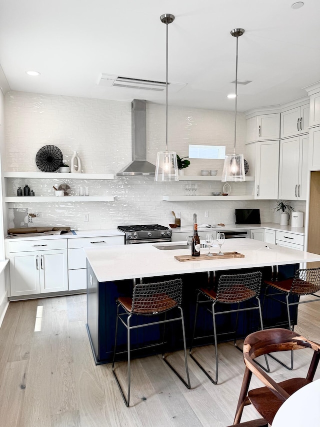30 Nats Ct, Charleston, SC 29403 - kitchen with wall chimney exhaust hood, open shelves, light wood-style floors, light countertops, and backsplash