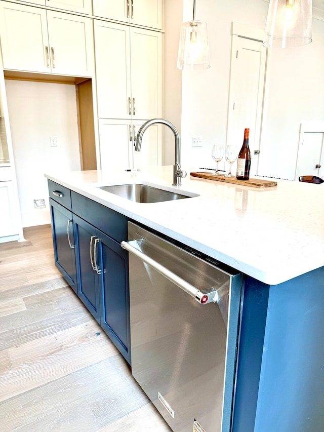 30 Nats Ct, Charleston, SC 29403 - kitchen featuring stainless steel dishwasher, blue cabinets, light wood-style floors, decorative light fixtures, and a kitchen island with sink
