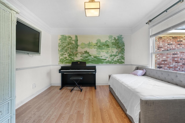 bedroom featuring ornamental molding and light hardwood / wood-style floors