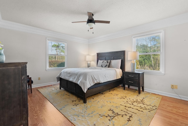 bedroom with crown molding, ceiling fan, hardwood / wood-style floors, and a textured ceiling