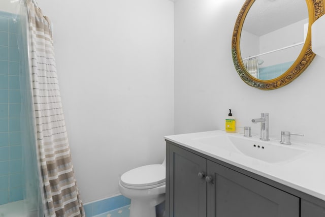 bathroom with vanity, toilet, and walk in shower