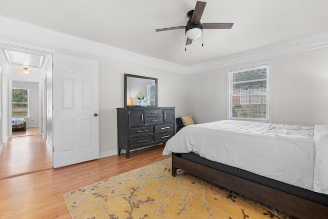 bedroom with ornamental molding, hardwood / wood-style floors, and ceiling fan