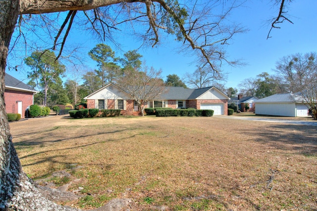 single story home featuring a garage and a front yard