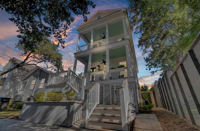 raised beach house featuring ceiling fan and a balcony