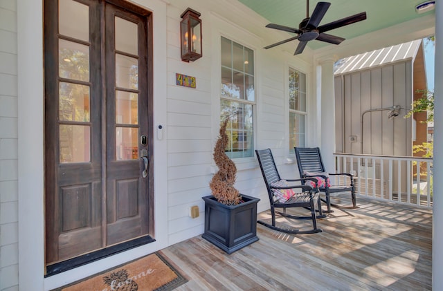 doorway to property featuring covered porch and ceiling fan