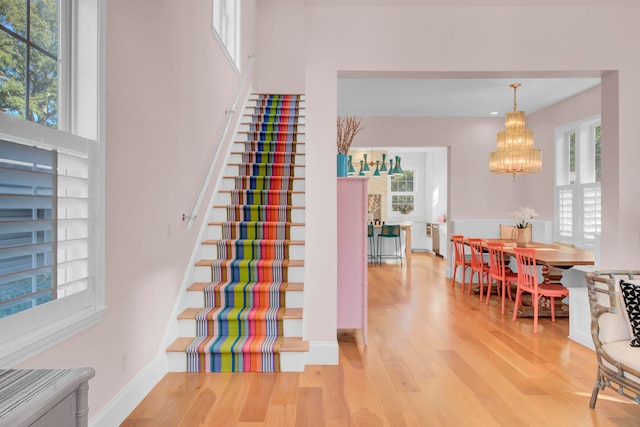 stairway featuring a chandelier and hardwood / wood-style flooring