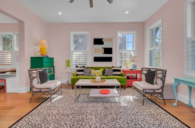 living room featuring light hardwood / wood-style flooring, a healthy amount of sunlight, and ceiling fan