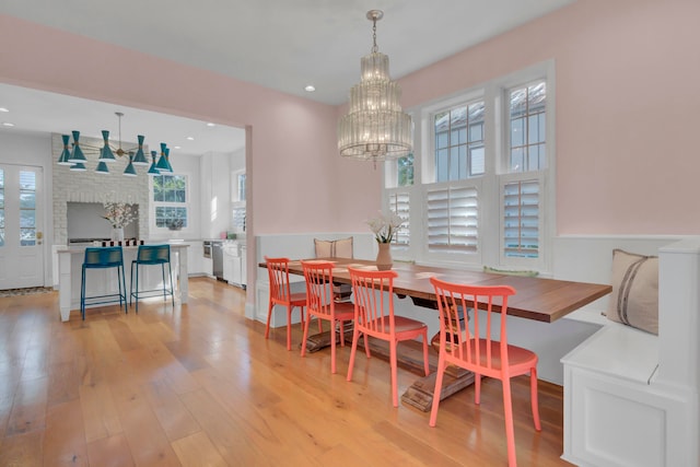 dining area with an inviting chandelier and light wood-type flooring