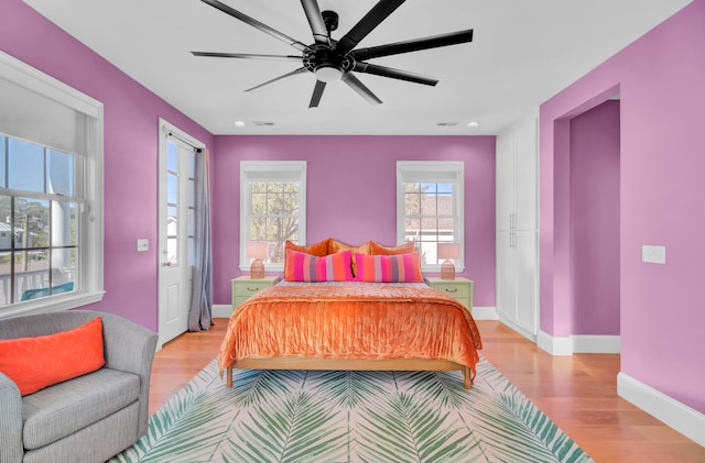 bedroom with light hardwood / wood-style floors and ceiling fan