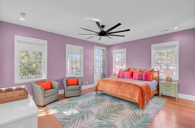 bedroom with ceiling fan and light hardwood / wood-style flooring