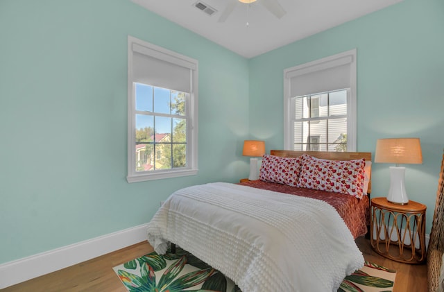 bedroom with wood-type flooring and ceiling fan