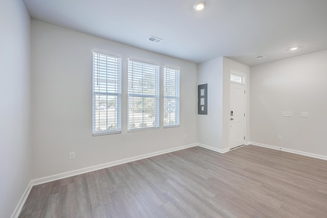 interior space featuring electric panel and light wood-type flooring