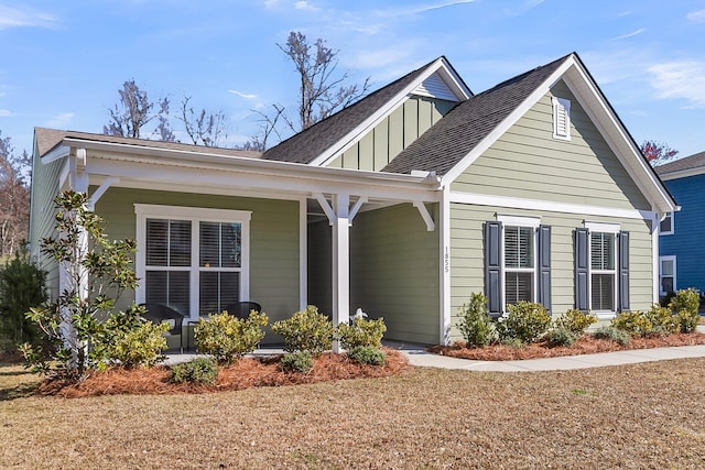 view of front of home featuring covered porch, board and batten siding, and roof with shingles