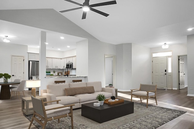 living room featuring ceiling fan, hardwood / wood-style floors, and high vaulted ceiling