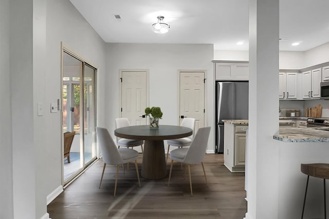 dining room with dark hardwood / wood-style flooring