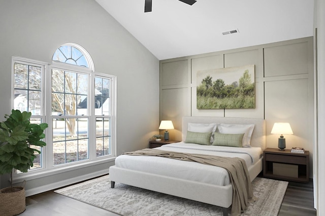 bedroom featuring multiple windows, dark hardwood / wood-style flooring, high vaulted ceiling, and ceiling fan