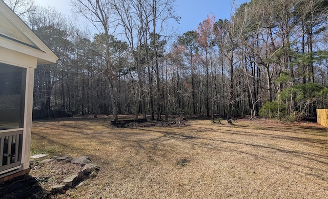 view of yard featuring a forest view