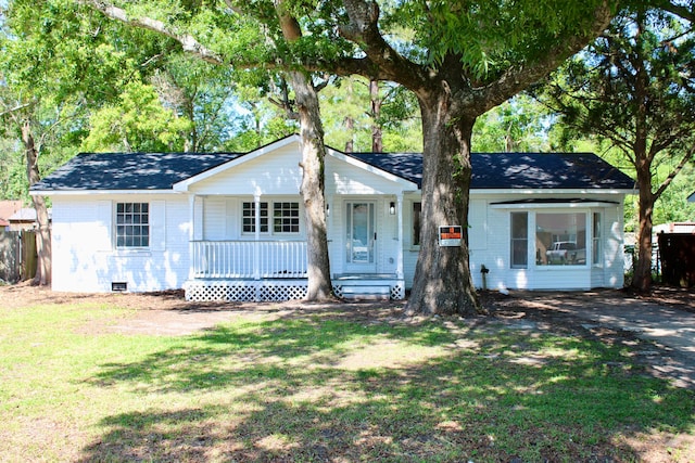 ranch-style house featuring covered porch, crawl space, brick siding, a front lawn, and a shingled roof