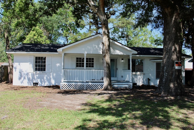 ranch-style home featuring a porch, a front lawn, crawl space, and brick siding