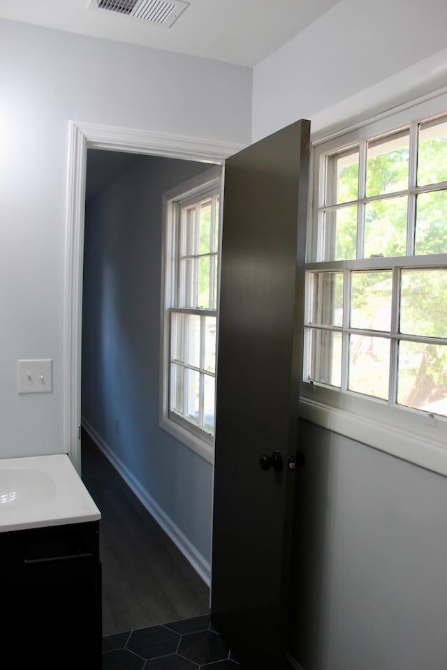 bathroom featuring tile patterned floors, visible vents, plenty of natural light, and vanity