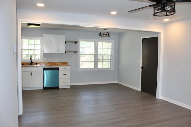 kitchen with white cabinetry, a sink, dark wood-type flooring, and dishwasher