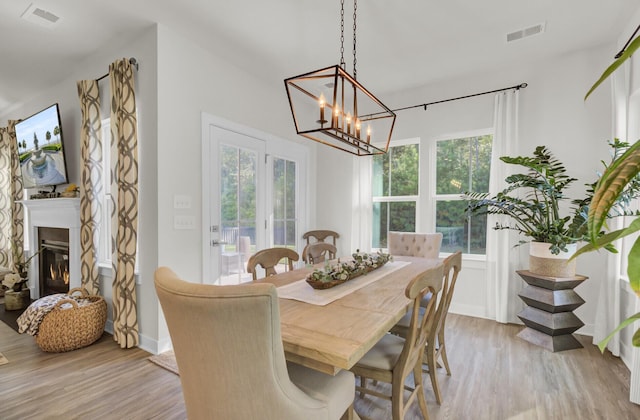 dining room featuring an inviting chandelier and light hardwood / wood-style flooring