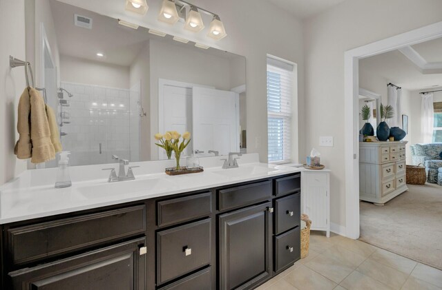 bathroom featuring tile patterned flooring, vanity, and an enclosed shower