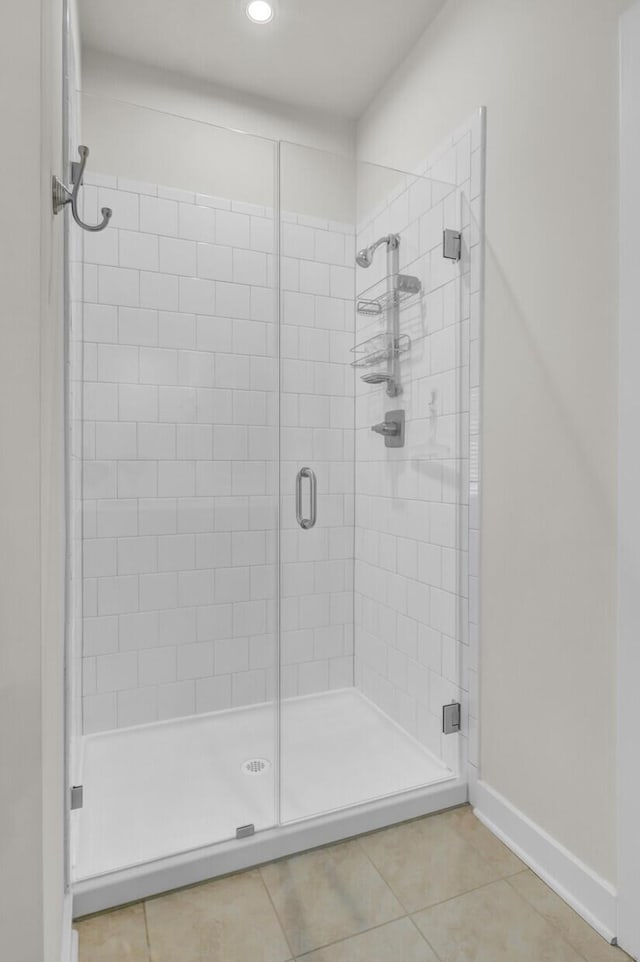 bathroom featuring tile patterned flooring and an enclosed shower